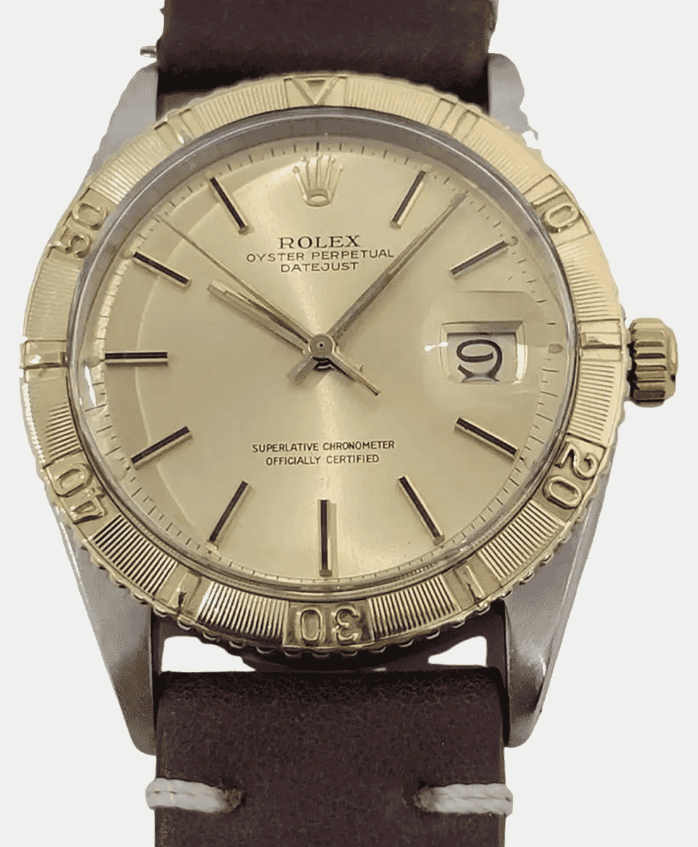 Rolex Datejust featuring a gold fluted bezel and a cream dial on a brown leather strap.