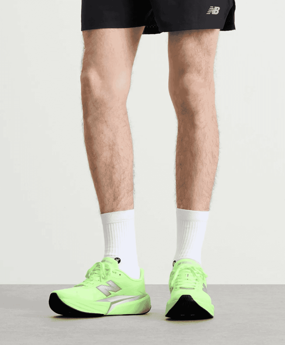 Runner wearing neon green New Balance Fuelcell Rebel v5 sneakers.