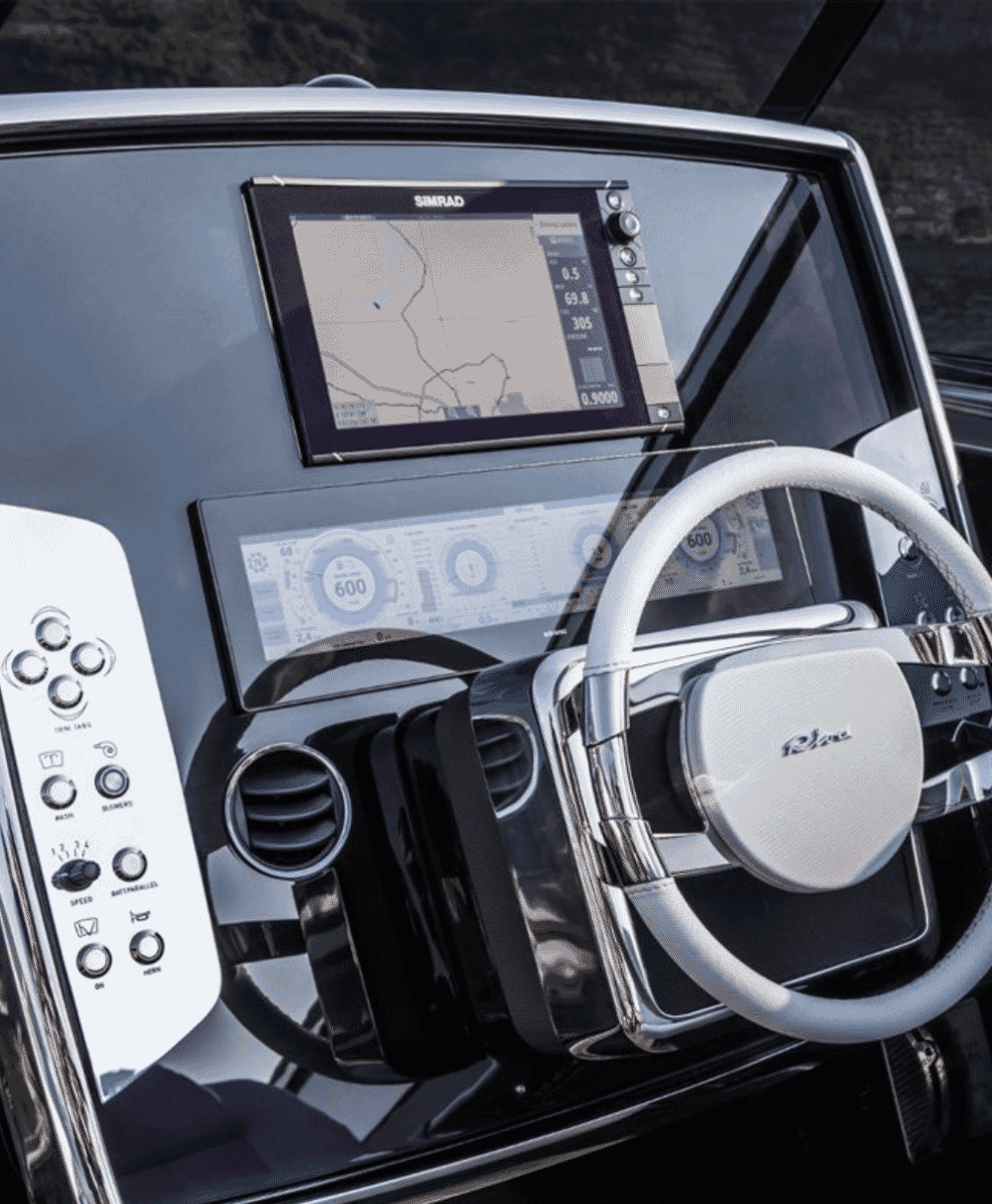 Close-up of a luxury yacht dashboard with Simrad screens and white leather steering wheel
