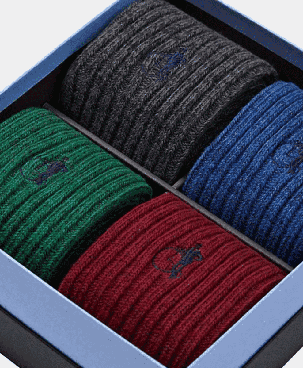 A gift box containing four pairs of colorful ribbed knit socks.