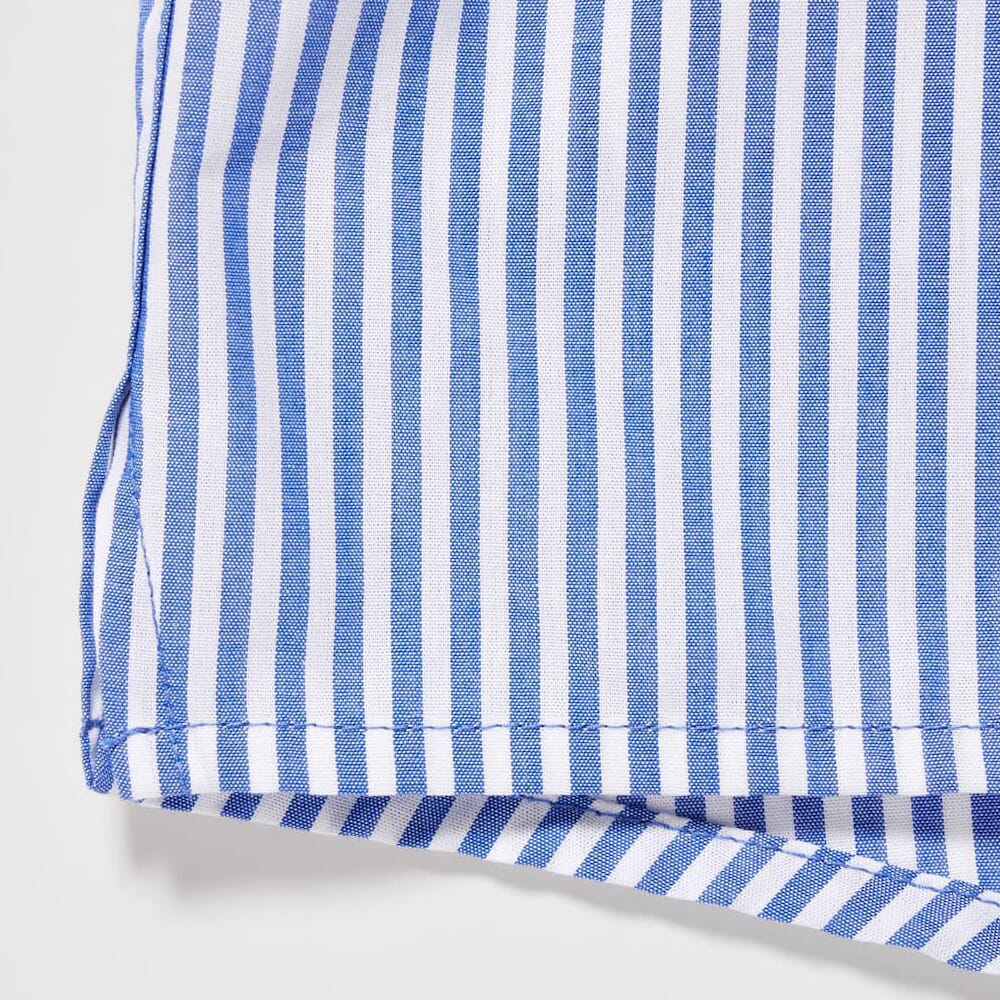 Close-up detail of blue and white vertical striped fabric showing the fine weave and stitching.