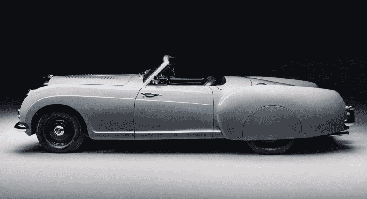 Sleek 1953 Bentley R-Type Continental convertible in monochrome showing its side profile.