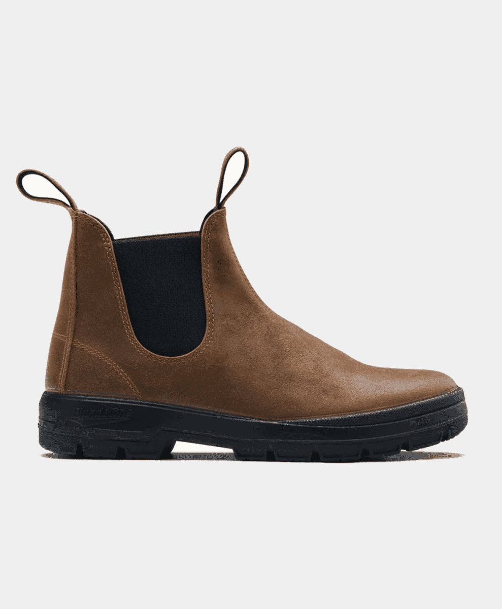Side profile of a brown suede Chelsea boot with black elastic panels against a white background.
