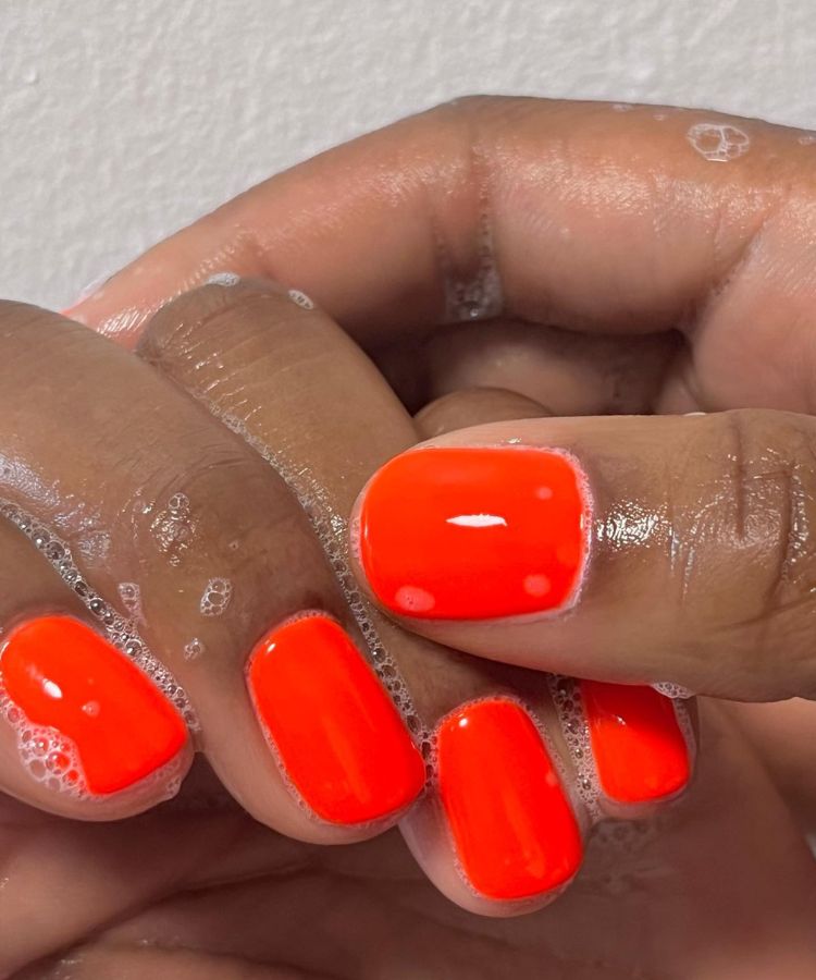 Sculptural jelly nails in a vibrant, semi-transparent pink hue.