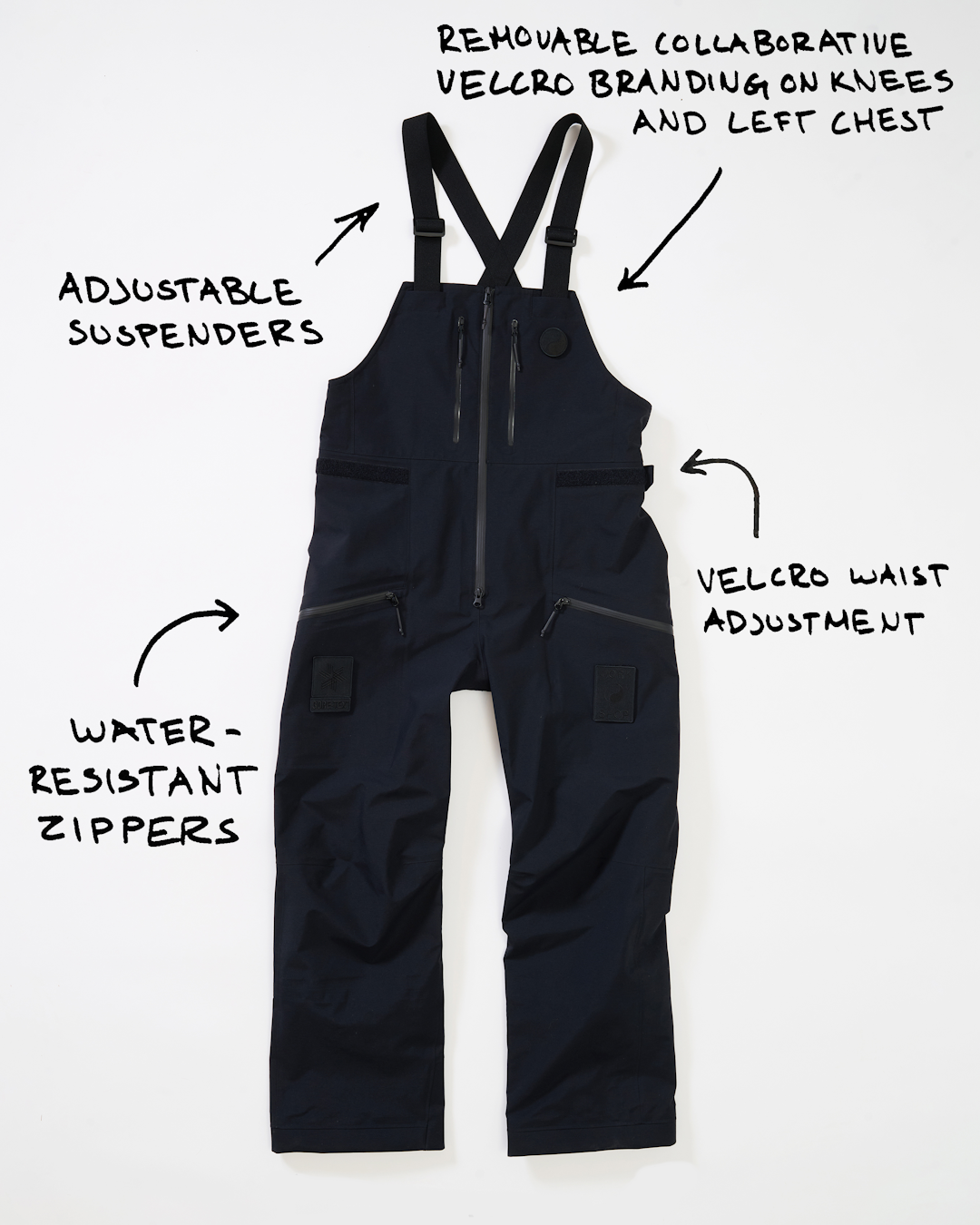 Black waterproof technical overalls with adjustable suspenders and collaborative branding.