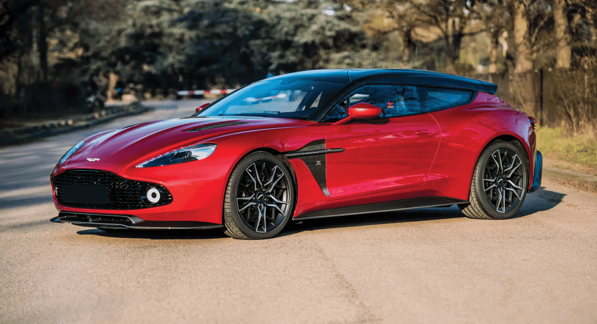 Close-up of a red Aston Martin Zagato's sleek exterior on a quiet road, highlighting its unique coachbuilt design.