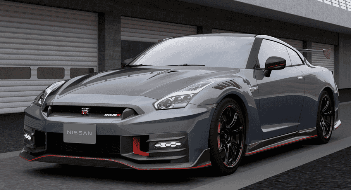 A gray Nissan GT-R NISMO with red trim parked in front of a contemporary architectural garage.