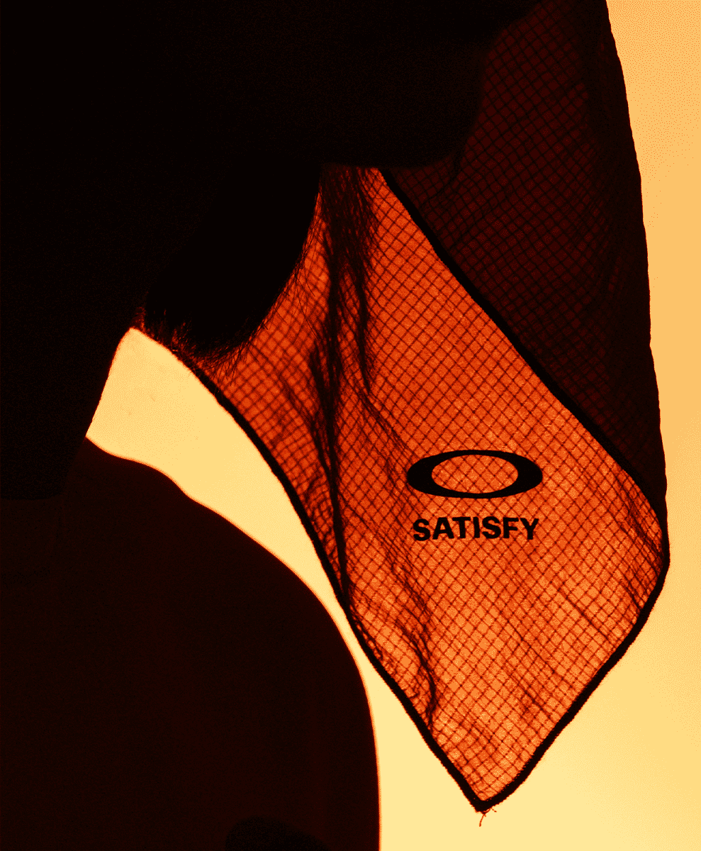 Close-up of a mesh neck gaiter with SATISFY and Oakley branding.