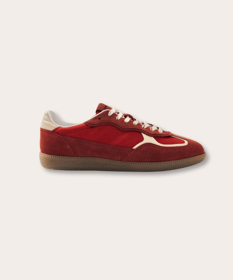 Leather sneakers with red accents and a gum sole.