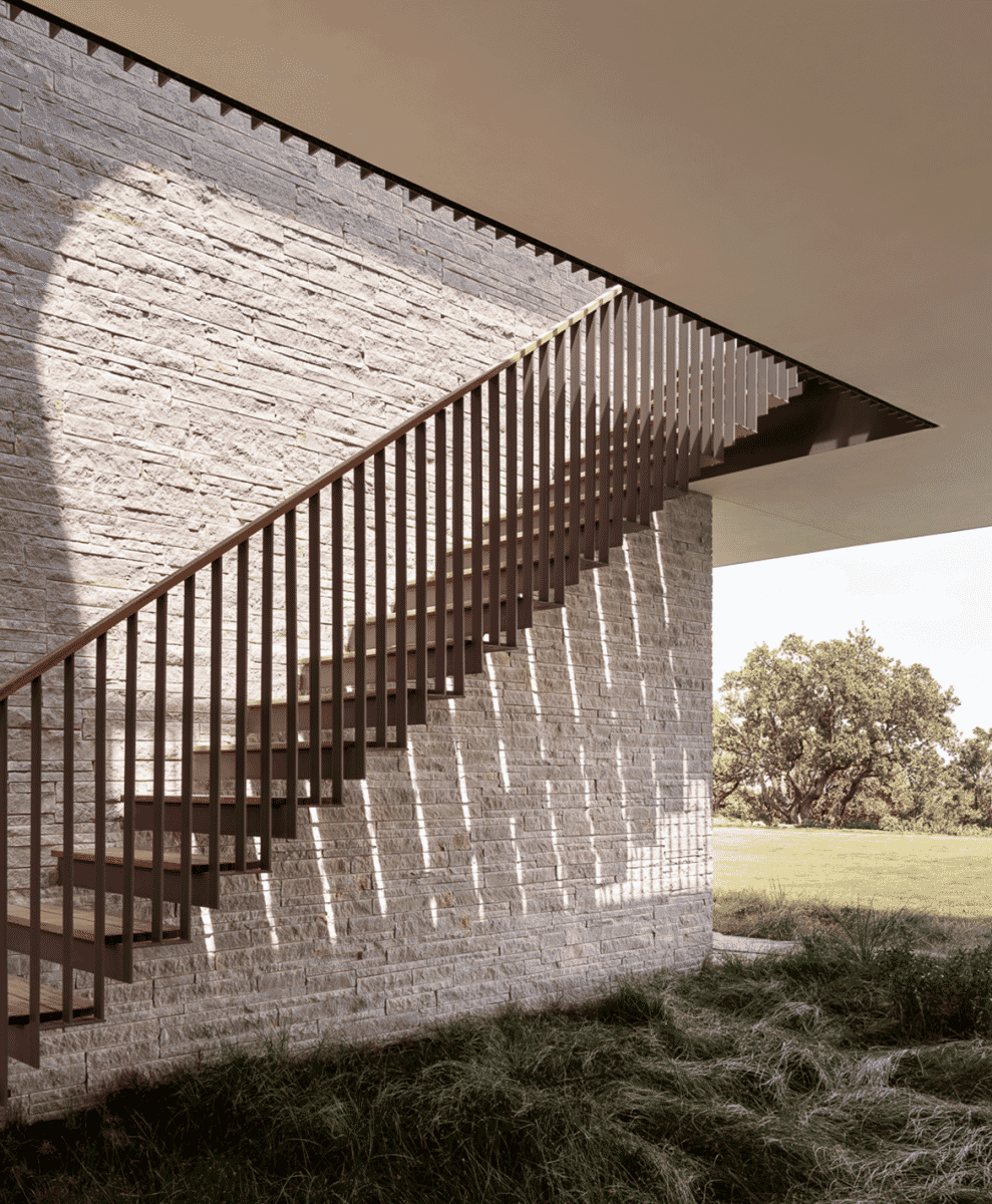 Modern outdoor staircase casting geometric shadows against a stone wall.