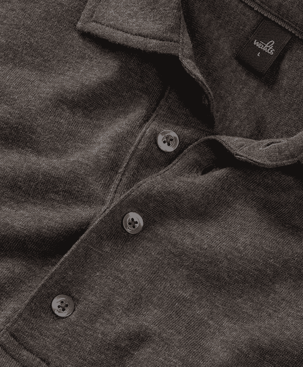 Close-up of a dark gray textured polo shirt with silver buttons and brand tag.