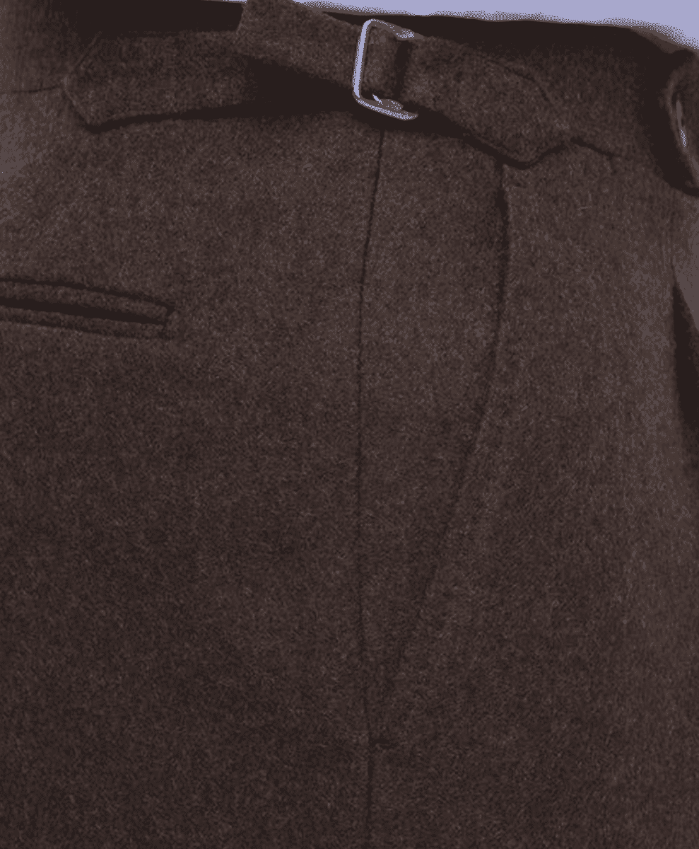 Close-up of brown flannel trouser fabric and pleat detail.