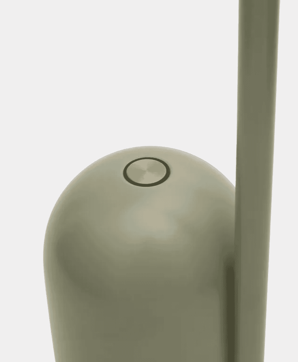 Close-up of a minimalist cylindrical lamp base with a power button.