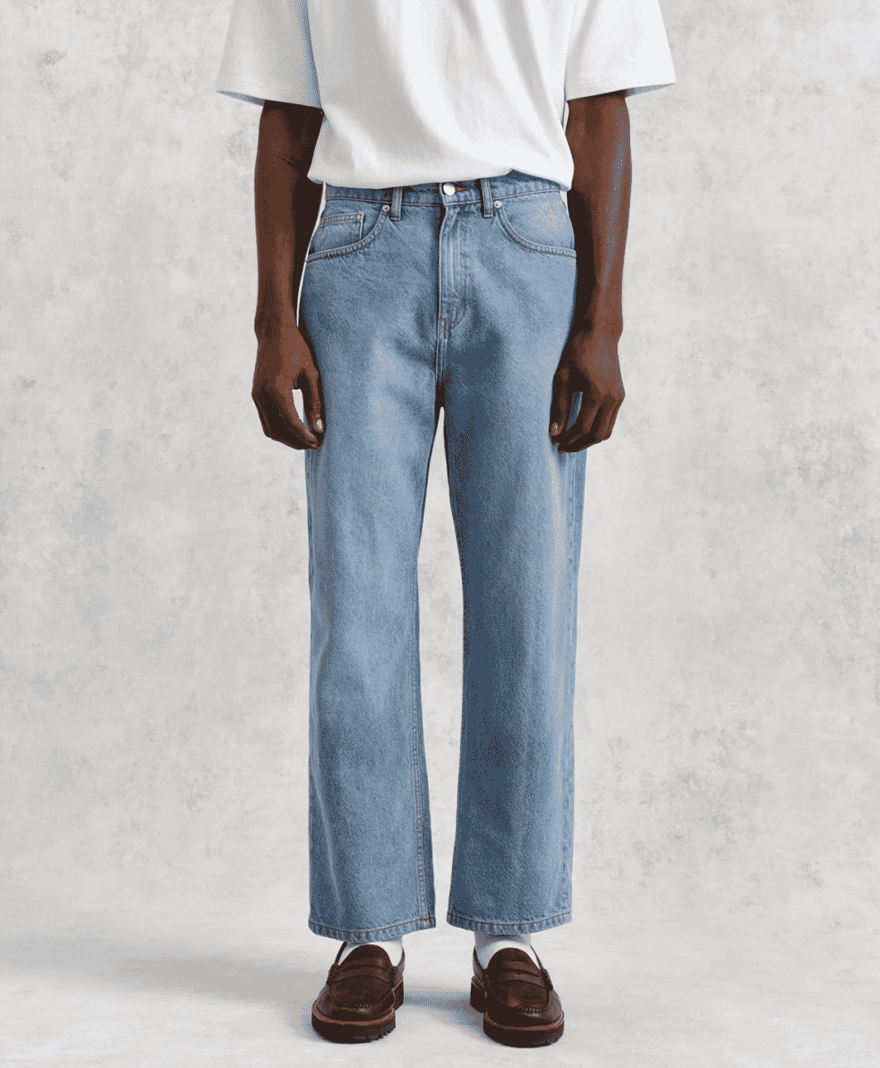 Model in light-wash wide-leg denim jeans showcasing a relaxed contemporary fit.