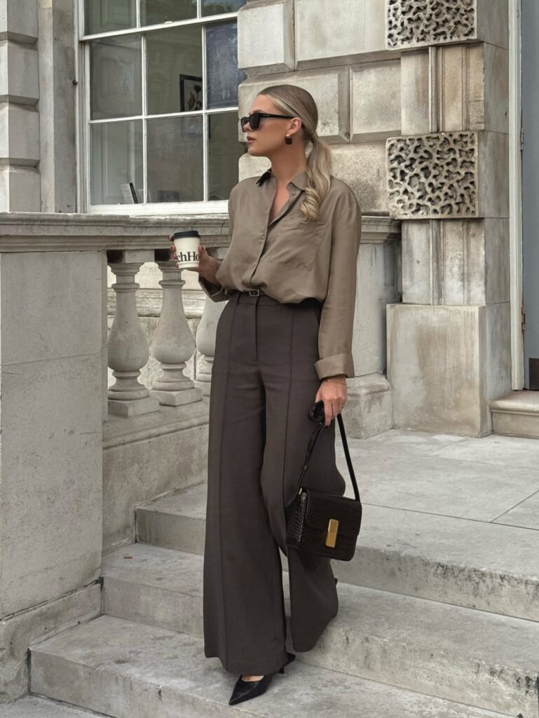 Woman wearing a monochromatic chocolate brown tailored suit for a professional fall look.
