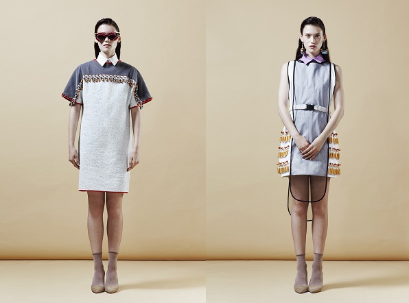 Two models in avant-garde minimalist dresses with geometric embroidery and structured silhouettes.