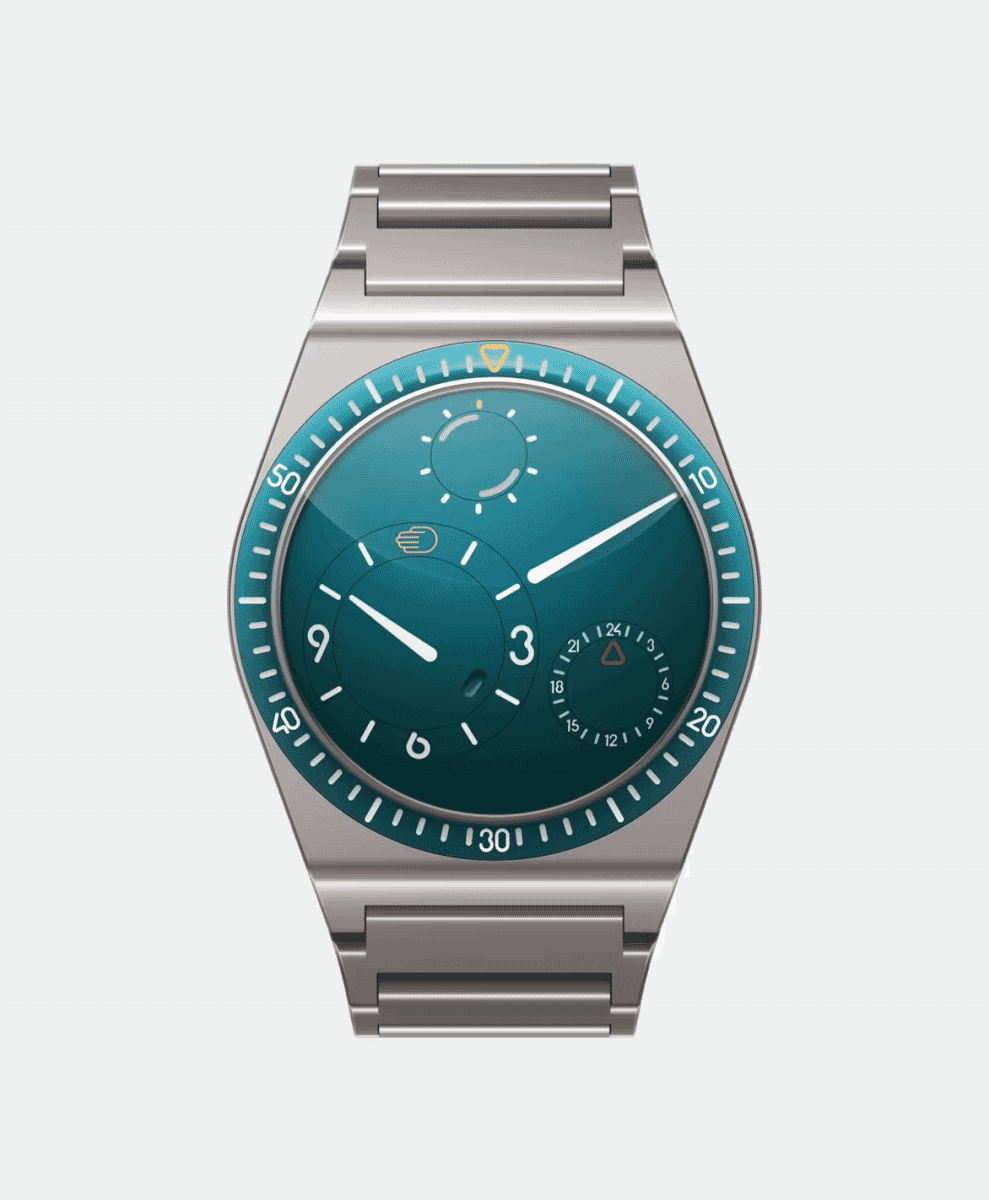 Frontal view of the Ressence Type 7 with a teal gradient dial and metallic case on a white background.