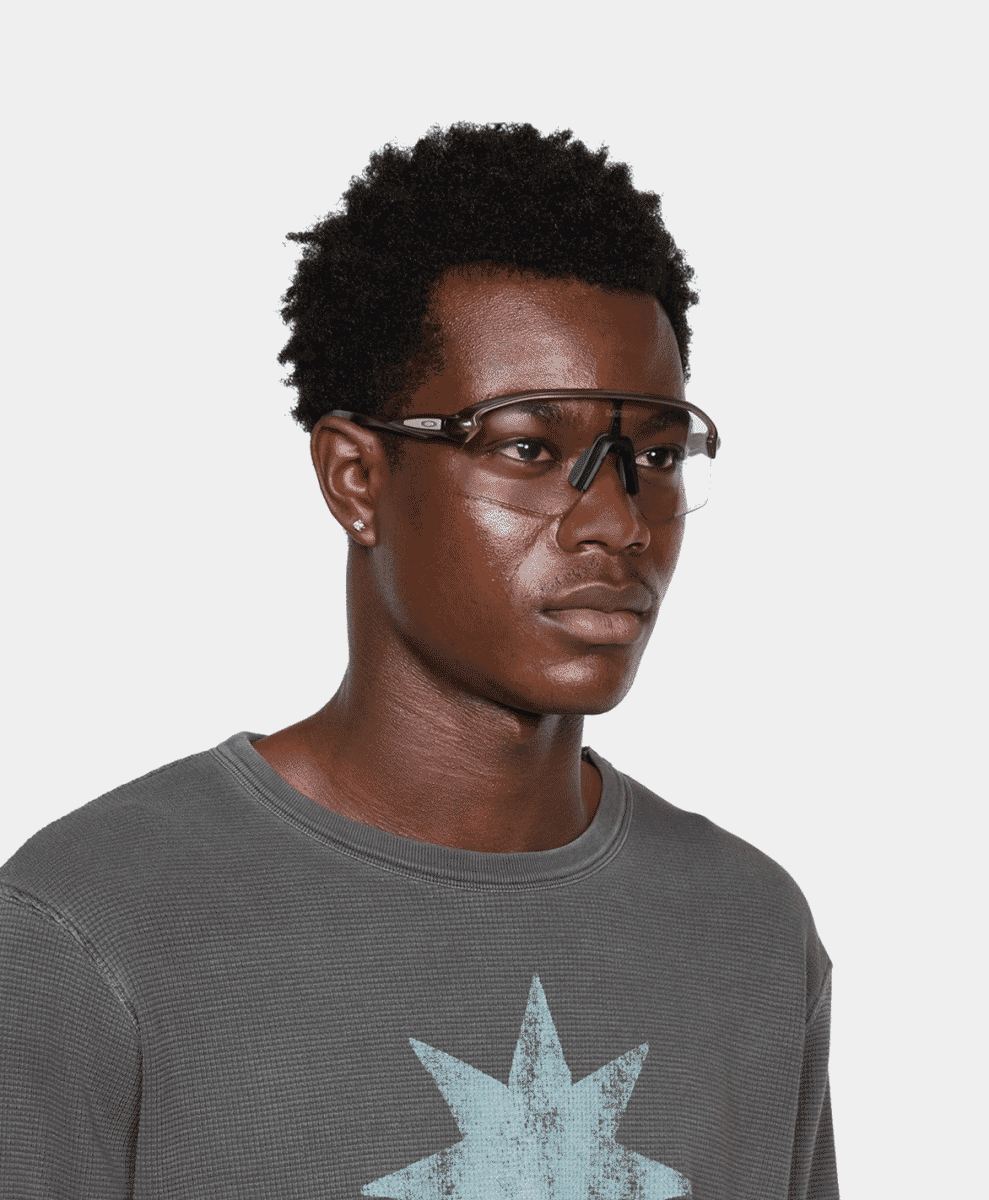 A man in a gray ribbed sweater featuring a light blue star graphic.