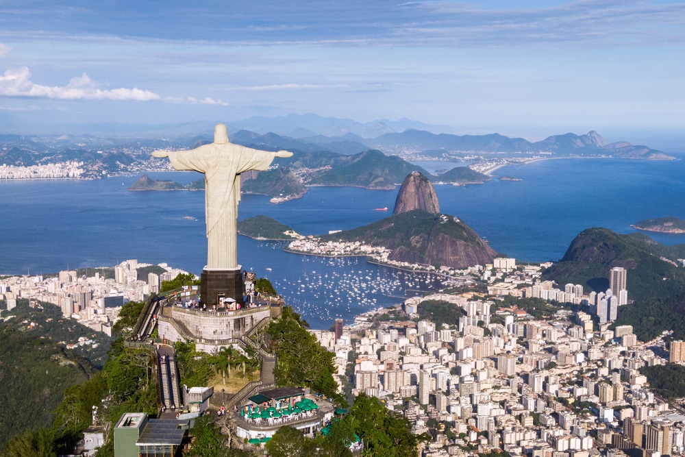 An aerial shot of the Christ the Redeemer statue overlooking the city and bay of Rio de Janeiro.