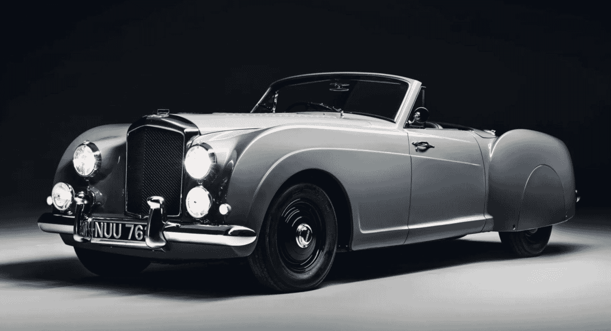 Monochrome profile shot of a 1953 Bentley R-Type Continental with elegant curves.