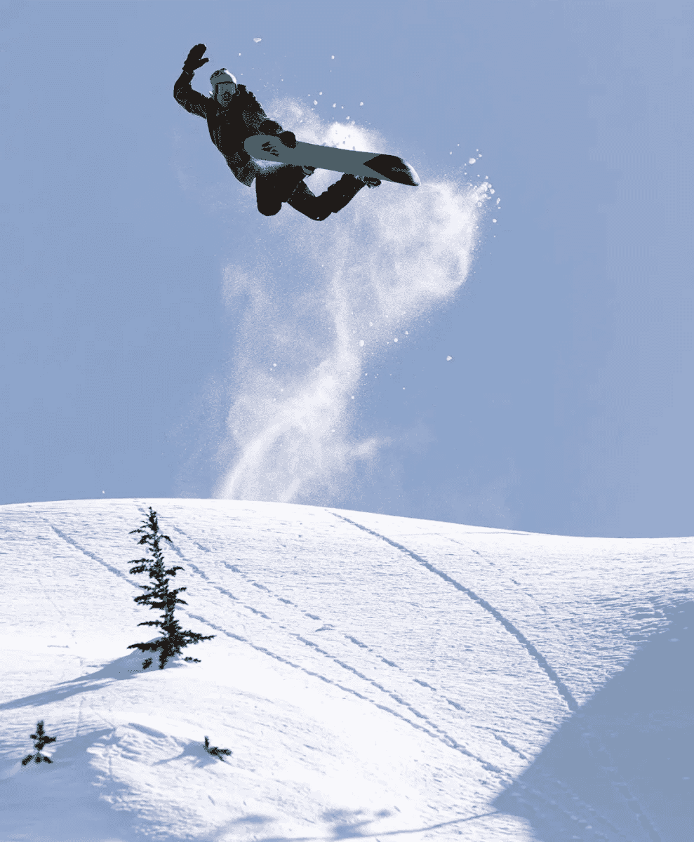 A snowboarder in dark winter gear executing an aerial maneuver over a snowy slope.