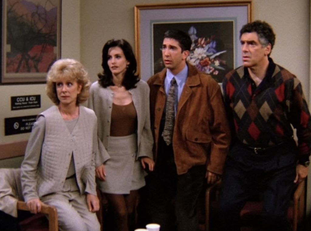 Screengrab of Monica Geller in an oversized cardigan and dark mini skirt.