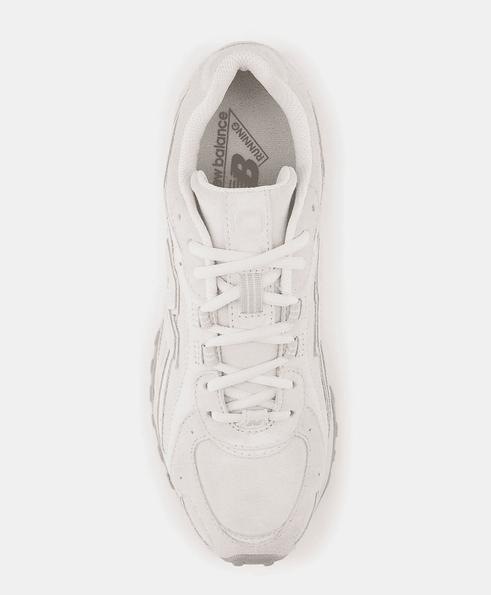 Top-down view of a white New Balance sneaker showing the lacing system and slim shape.