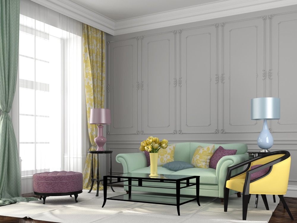 Mint green sofa and yellow armchair set against ornate grey wall paneling.
