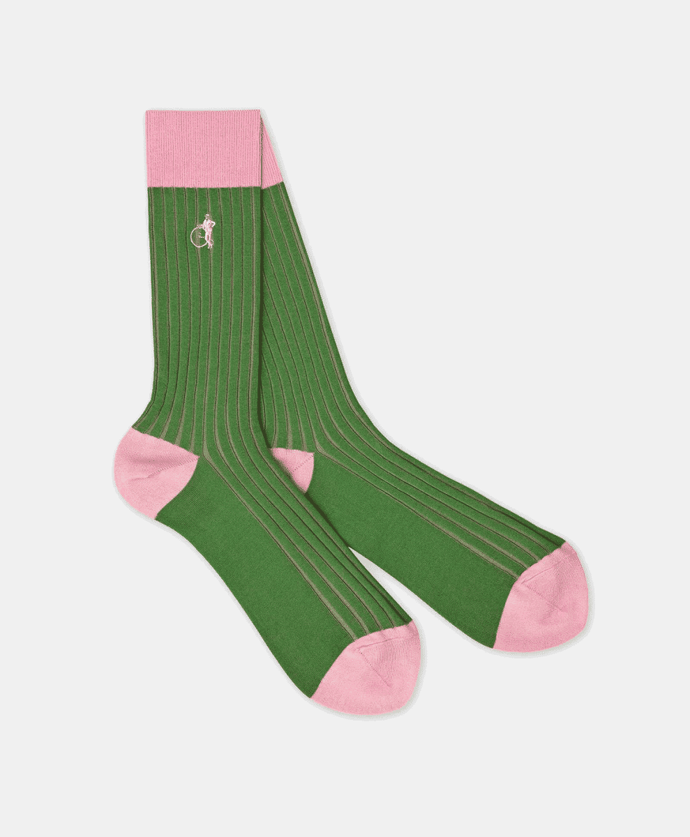 A green ribbed dress sock with pink accents and an embroidered cyclist logo on a white background.