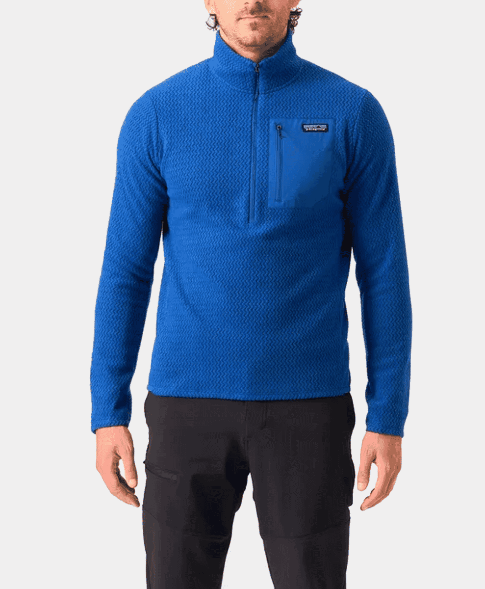 A man wearing a vibrant blue technical fleece pullover with a half-zip.