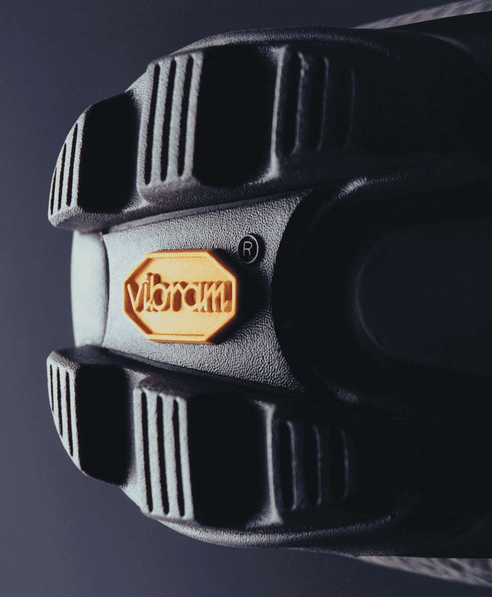 Close-up of a black cycling shoe sole featuring the orange Vibram logo and rugged tread.