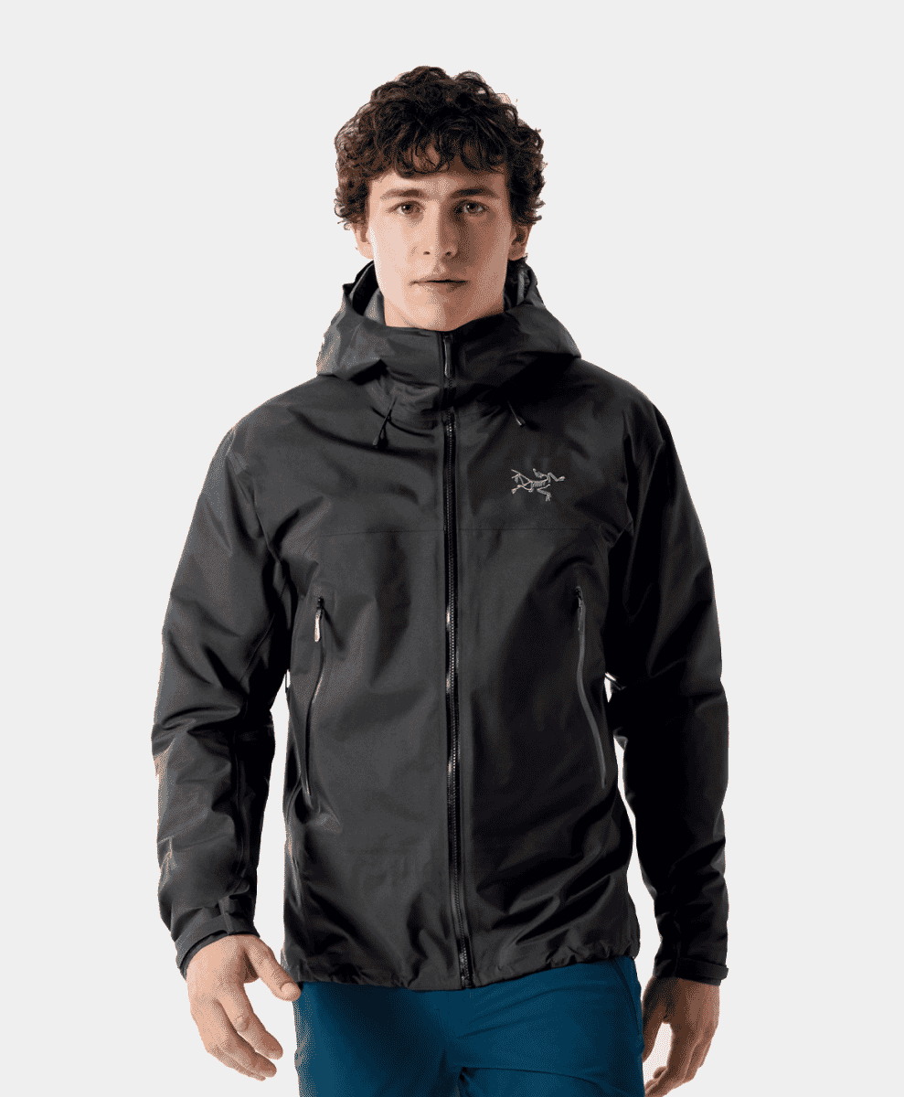 Man modeling a black Arc'teryx Beta SL technical waterproof jacket with a hood.