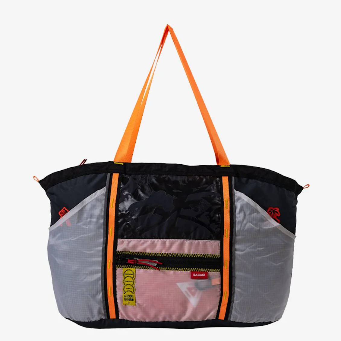 Multi-panel colorful duffel bag with orange straps and pink front pocket.