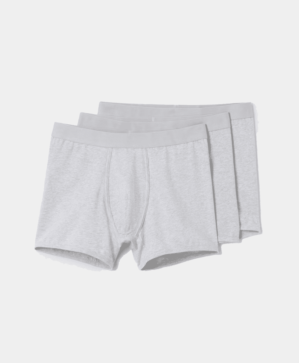 A stack of three light gray heathered men's boxer briefs with elastic waistbands.