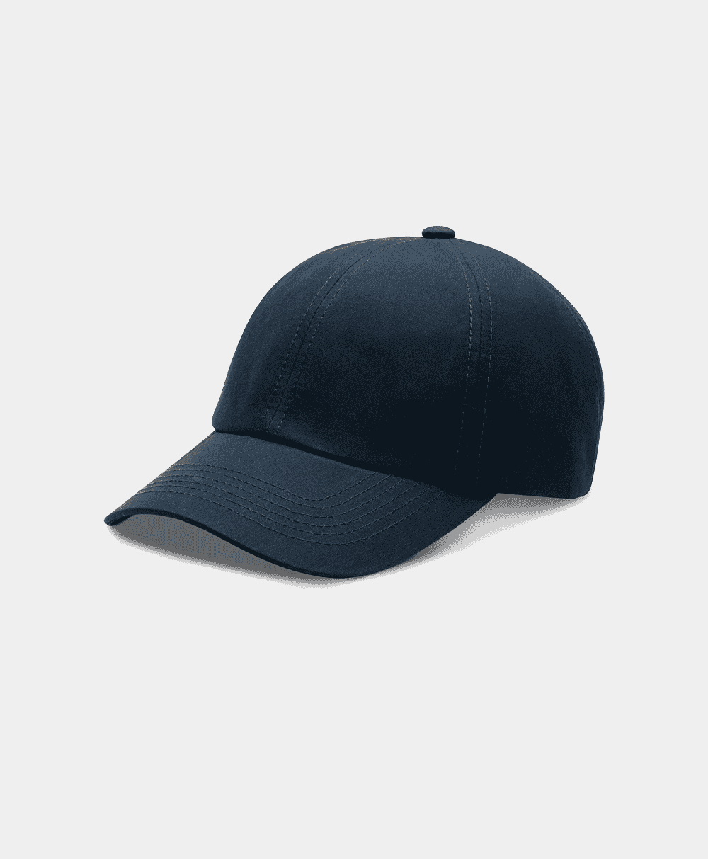 A navy blue baseball cap with structured panels and a curved brim on a white background.