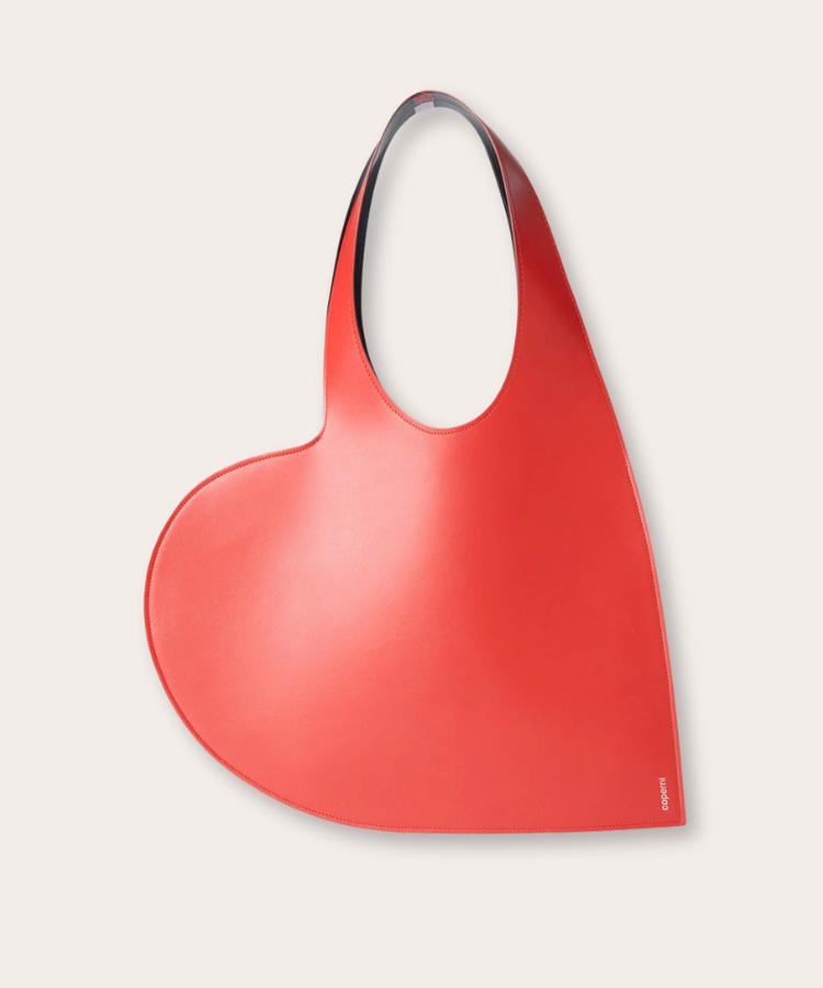 Miniature black tote bag with a heart-shaped cutout handle.