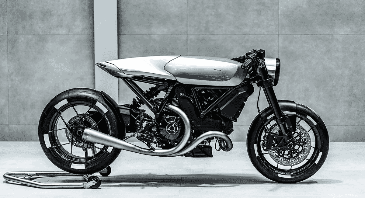 Mid-shot of a silver aluminum fuel tank and exposed mechanical engine parts of a custom motorcycle.