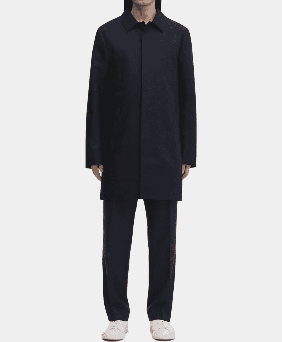 A model in a long navy car coat with a clean, minimalist silhouette.
