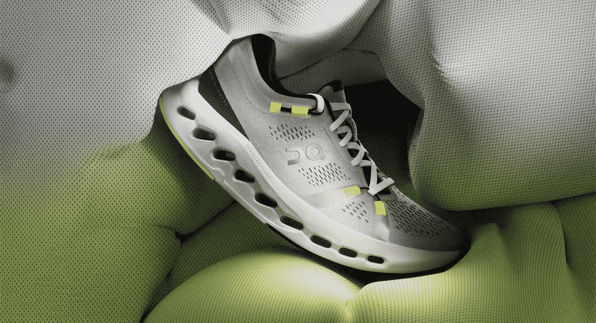 A modern grey and white Cloudsurfer 2 running shoe showing the mesh upper and sculpted sole.