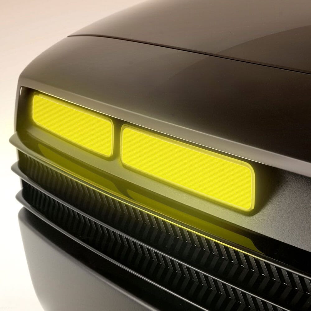 Close-up of the front grille featuring four rectangular glowing yellow LED modules.