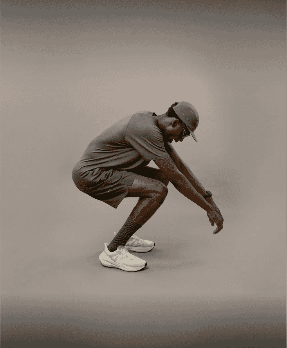 Man in olive shorts and a gray t-shirt in an athletic pose