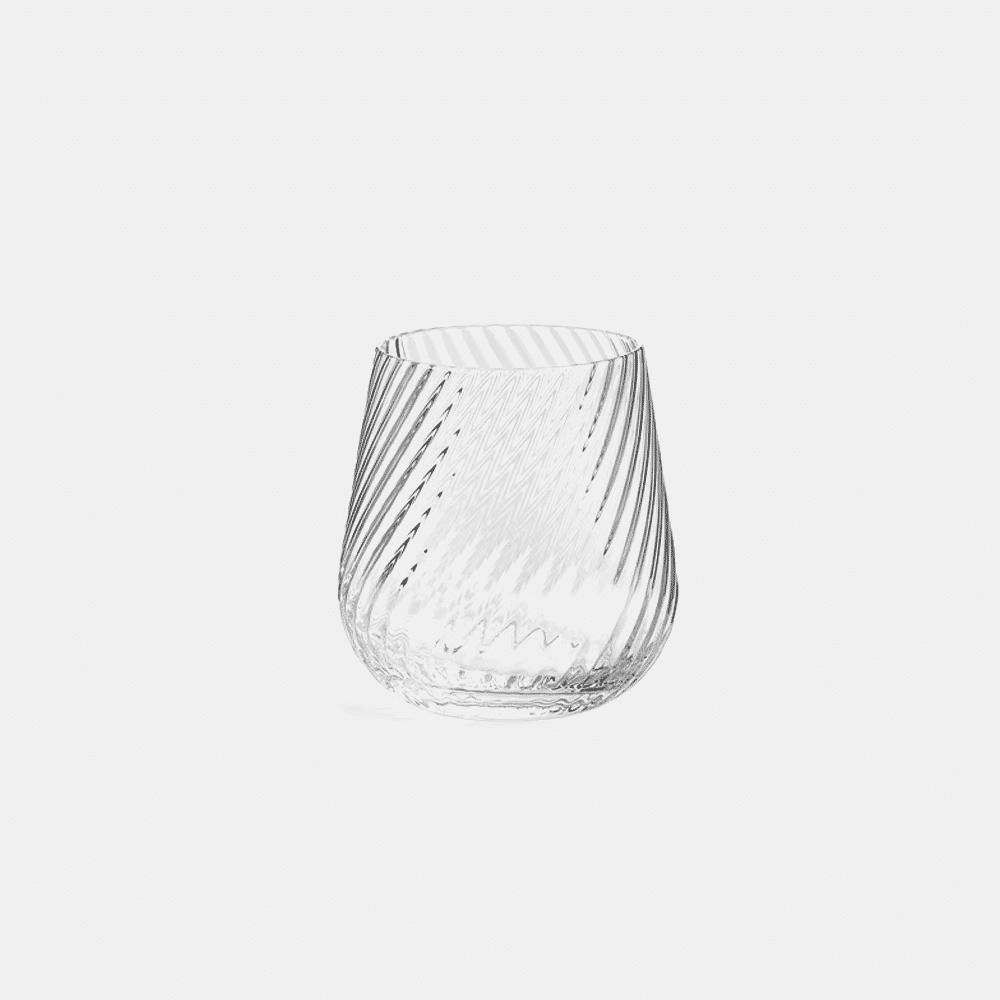 Close-up of a clear glass tumbler with a diagonal ribbed texture against a white background.