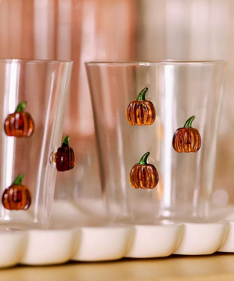 Clear juice glass featuring a small 3D glass pumpkin icon at the bottom.