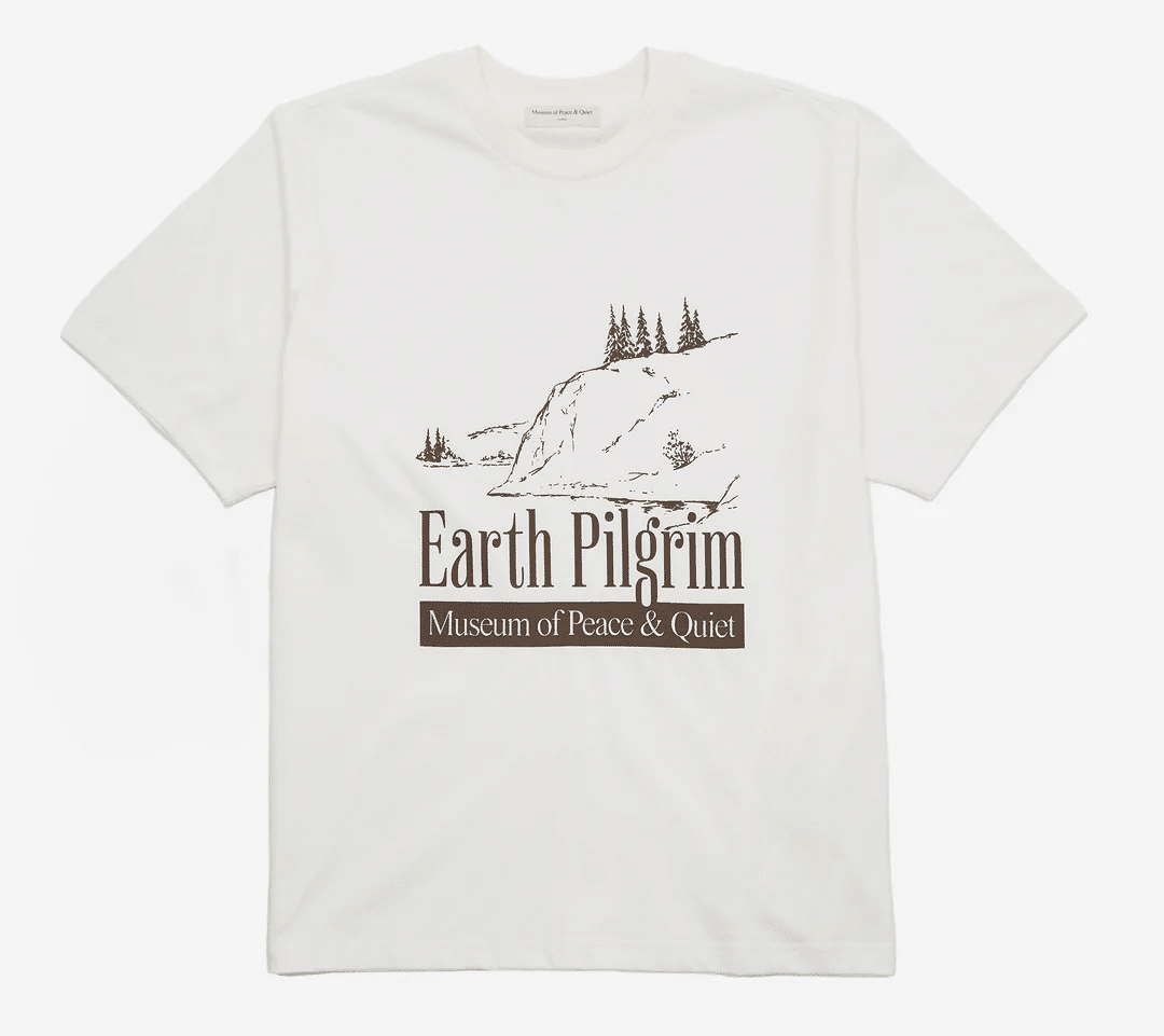 White graphic T-shirt with 'Earth Pilgrim' mountain illustration and text.