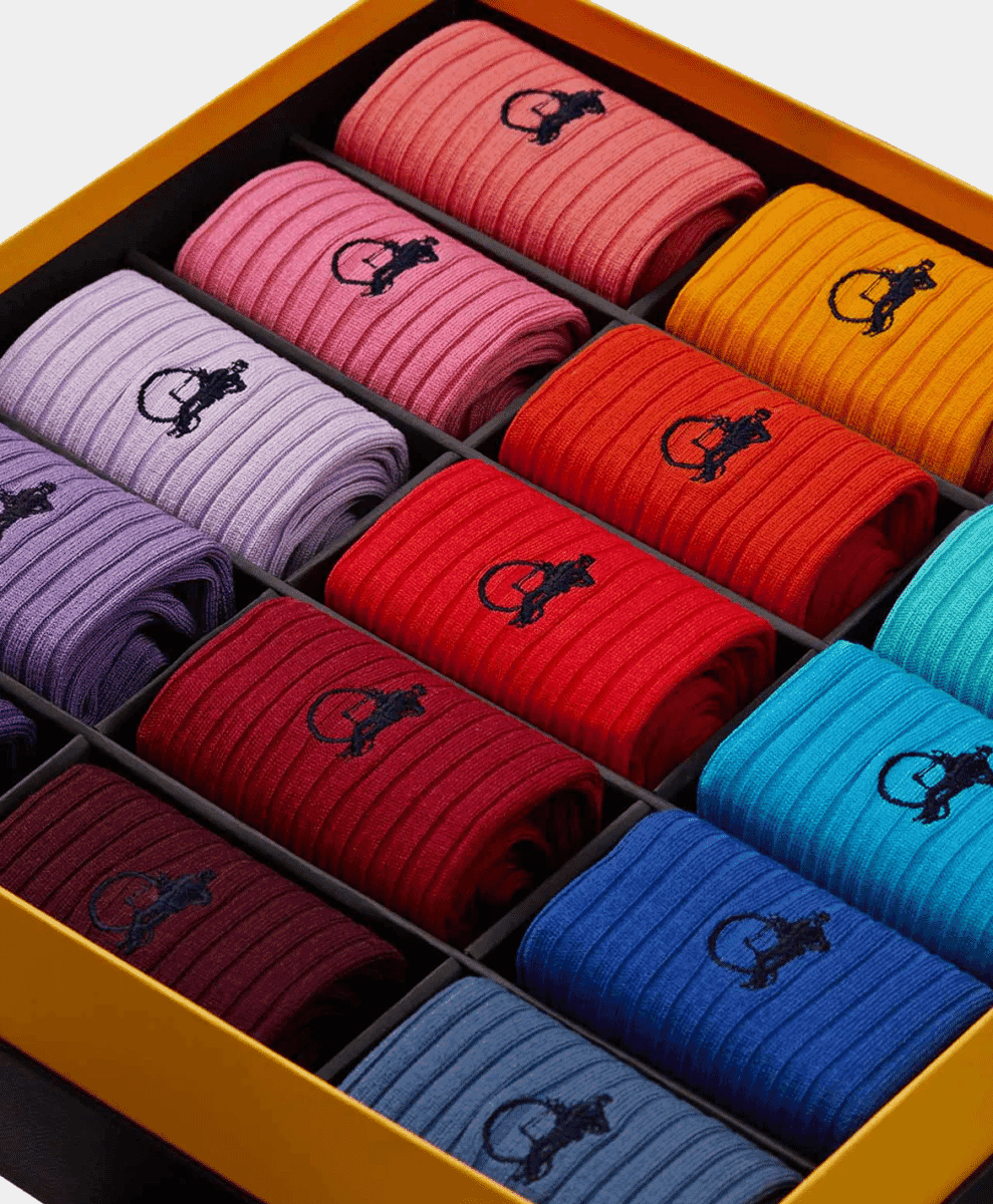 Luxury gift box containing twelve pairs of colorful ribbed men's socks.