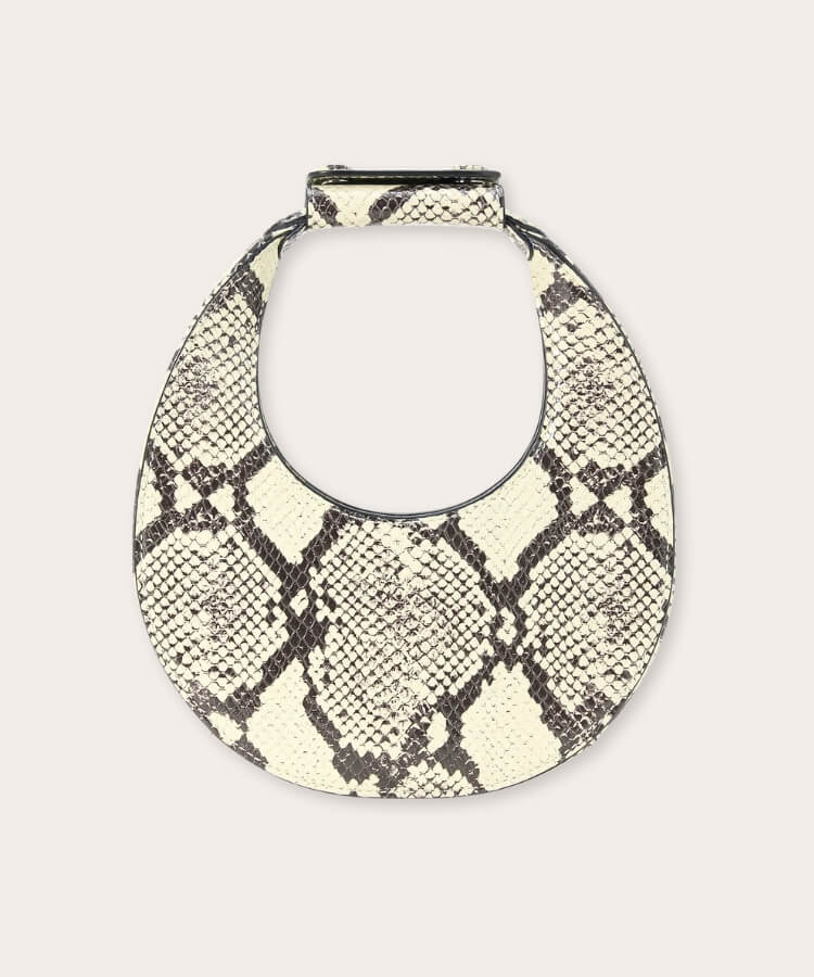 Staud snakeskin moon bag with a distinctive curved silhouette.