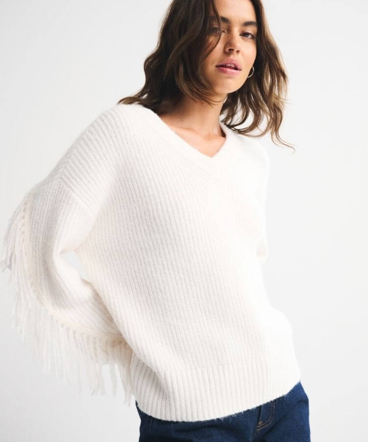Abercrombie & Fitch Fringe V-Neck Sweater in a neutral tone.