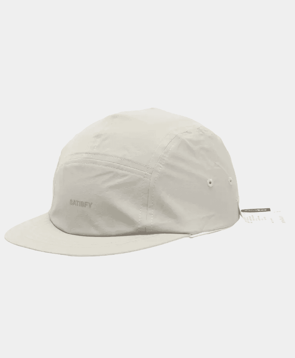 Minimalist beige five-panel cap with 'SATISFY' embroidery.