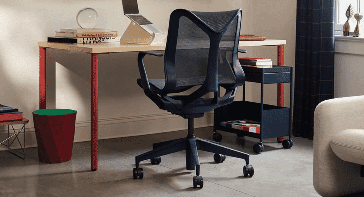 Modern ergonomic office chair with blue mesh and red accents in a contemporary home office.