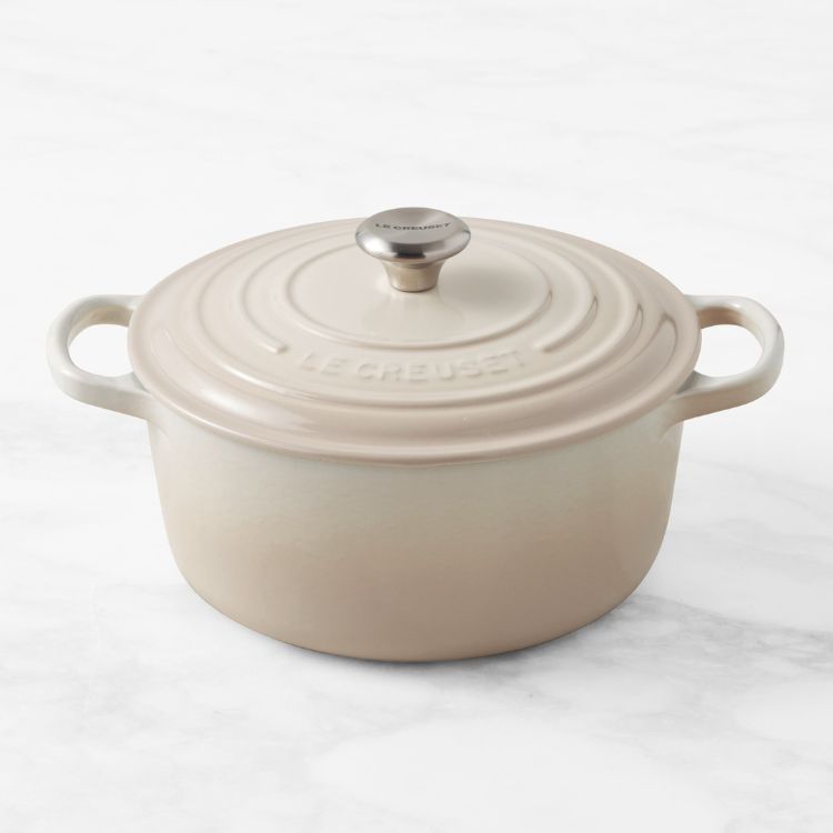 A white enameled cast iron Dutch oven.